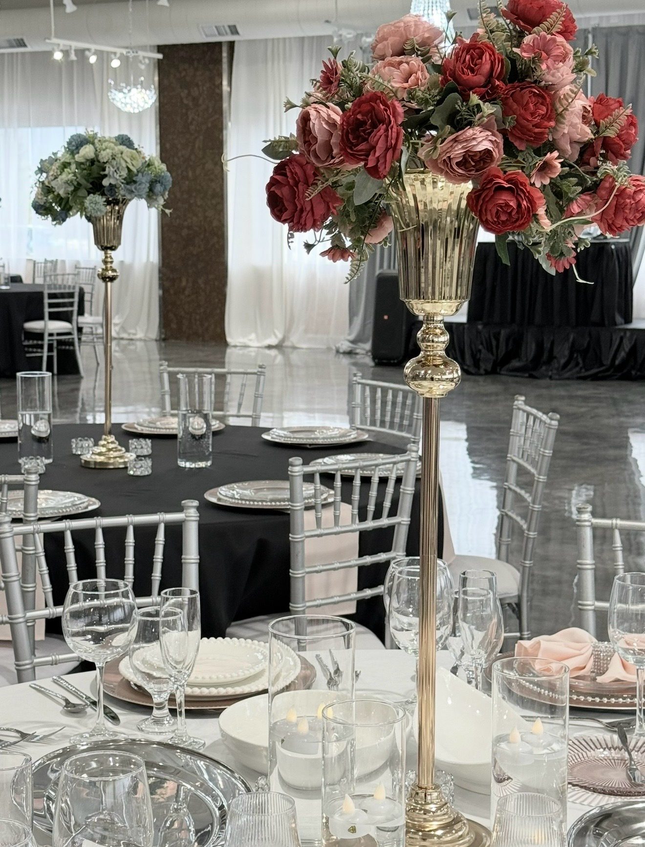 Tall gold centerpieces with red and blush roses