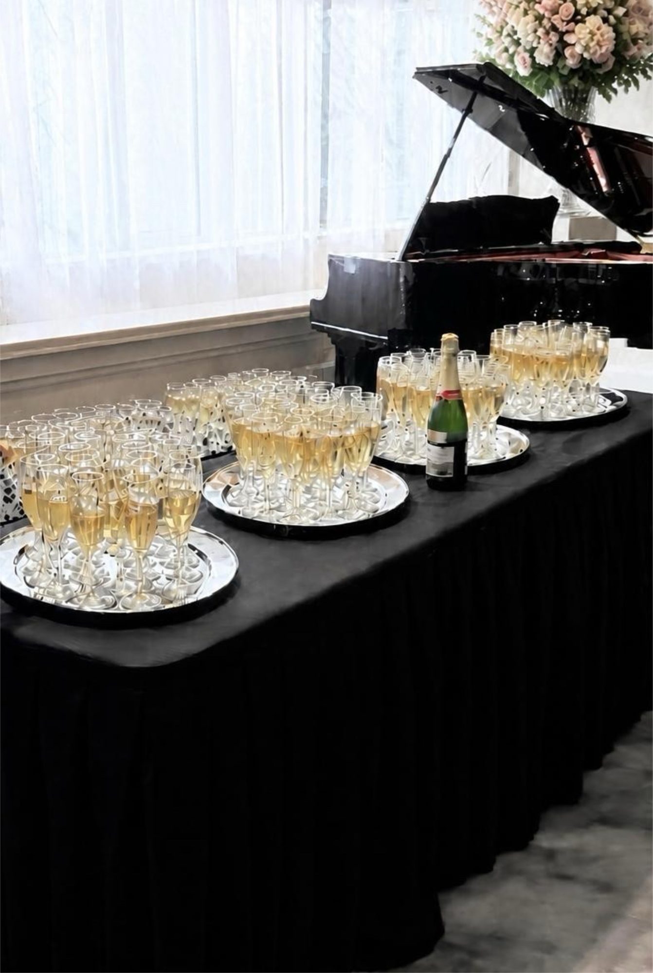 Champagne glasses set for a toast beside the grand piano